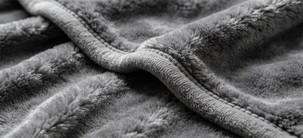 Plush Raschel blanket surface shown close up for material and workmanship review