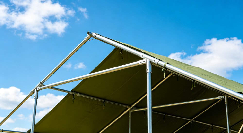 Field deployed emergency shelter showing robust frame construction waterproof material and practical design features meeting international standards for disaster response and refugee accommodation