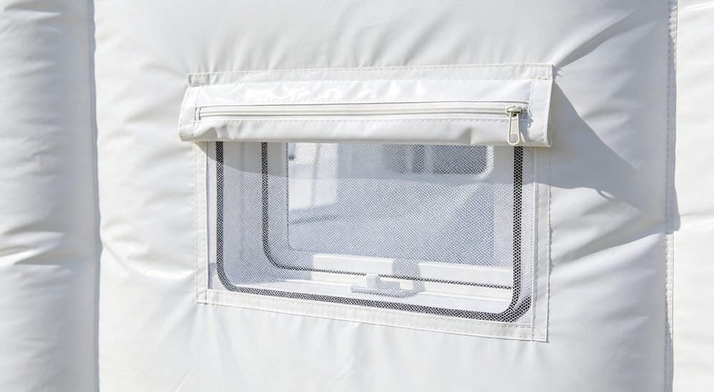 Ventilation window on inflatable medical tent, close-up of adjustable vent, bright lighting red and white inflatable emergency shelter for disaster relief operations