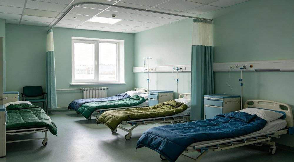 Wide angle view of hospital ward with sleeping bags arranged for patient rest medical facility accommodation Wide angle view of hospital ward with sleeping bags arranged for patient rest medical facility accommodation