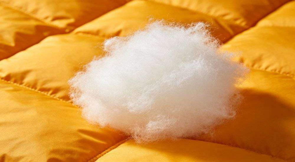 Close up of sleeping bag insulation filling material hollow fiber polyester wadding warm insulation sample Close up of sleeping bag insulation filling material hollow fiber polyester wadding warm insulation sample