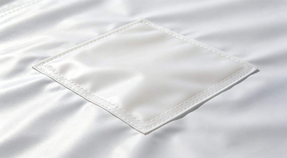 Patched repair result showing clean finish, close-up detail maintenance and repair for long term tent use in field conditions red and white inflatable emergency tent for disaster relief operations