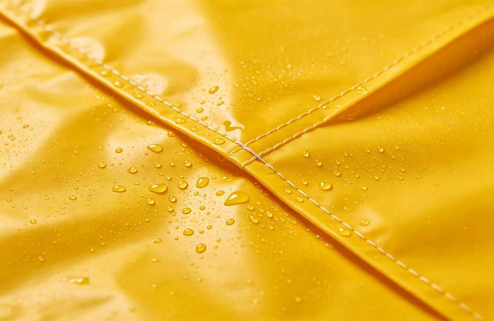 Closeup of heat-taped seam on a heavy duty rain poncho showing why taped seams prevent leaks in prolonged heavy rain.